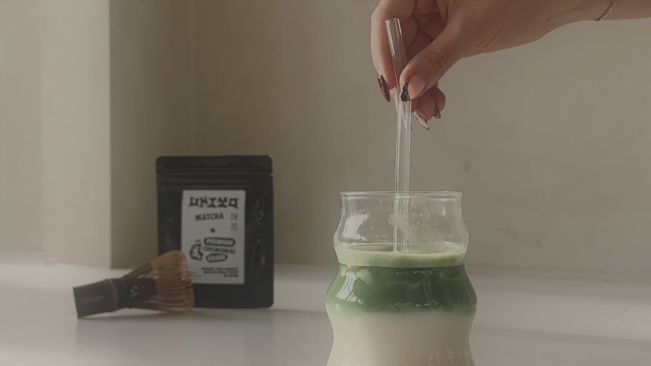 Stirring matcha in milk premium ceremonial matcha whisk 
