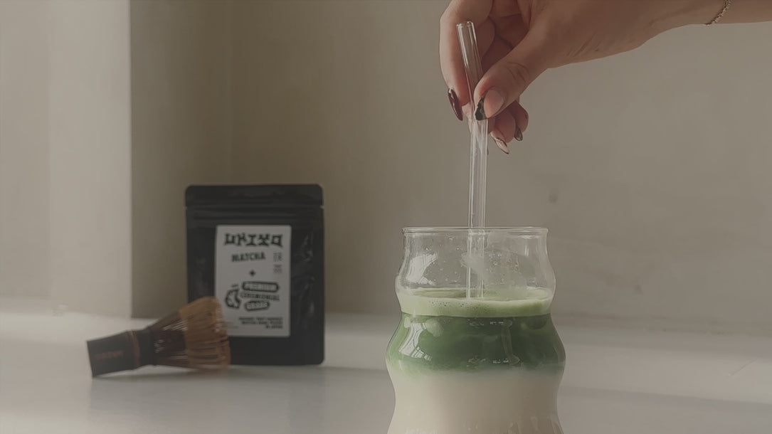 Stirring matcha in milk premium ceremonial matcha whisk 